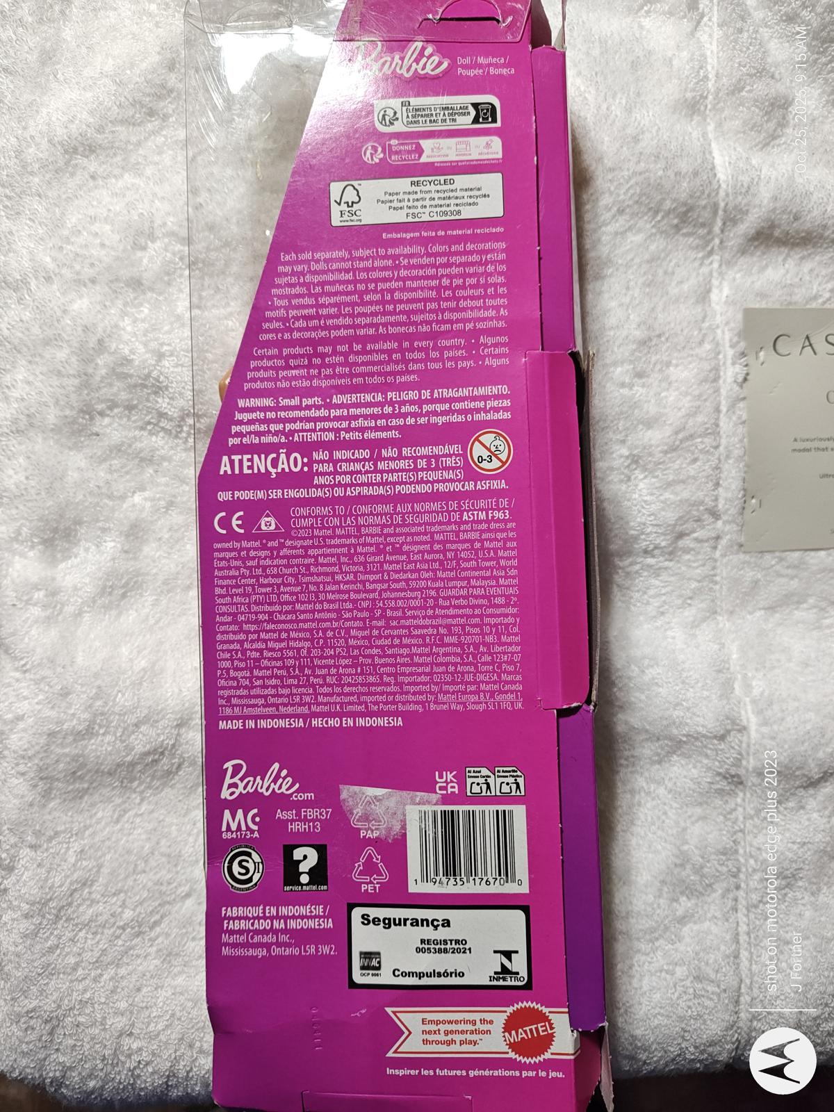 Barbie doll packaging featuring vibrant pink design and product details on the back.