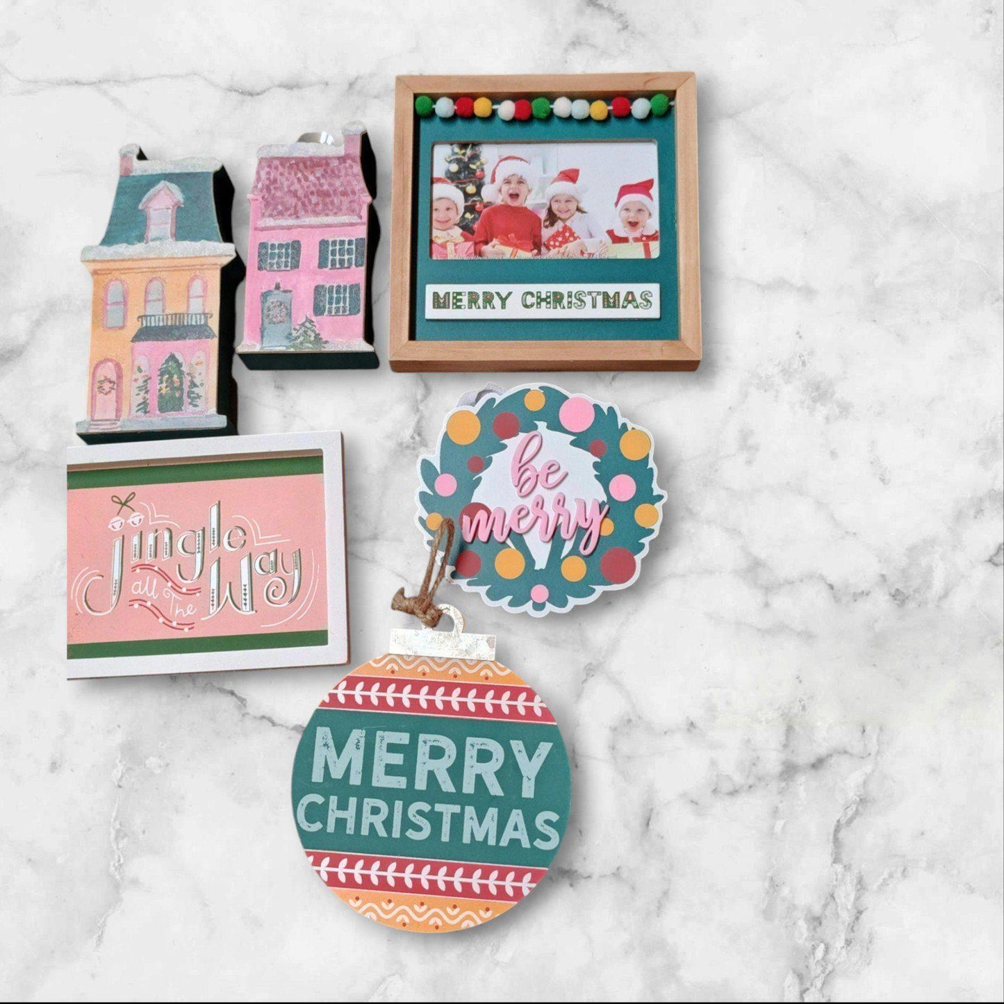 Merry Christmas decor set featuring colorful ornaments, festive cards, and a framed photo.