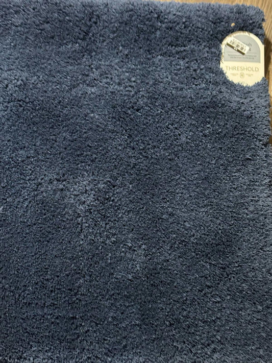 Threshold navy blue plush area rug with soft texture and tag.