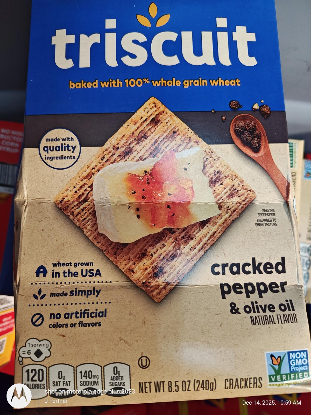 Triscuit cracked pepper and olive oil crackers with a topping of cream cheese and herbs.
