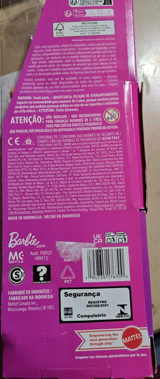 Barbie packaging featuring bright pink design and safety warnings.