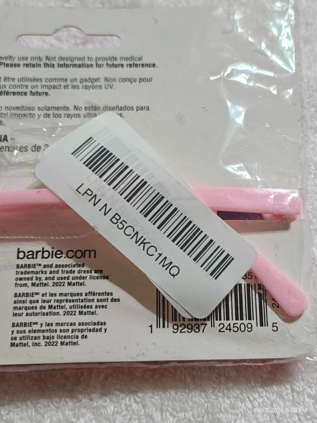 Barbie pink hair accessories set featuring styling tools and packaging details.