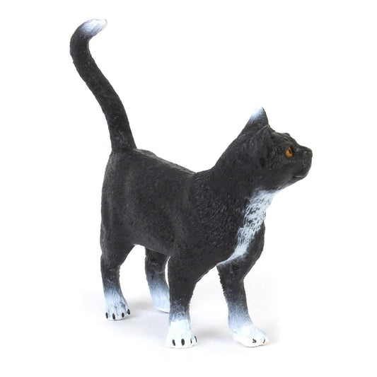 Black Cat figurine with white paws and chest, looking upwards.