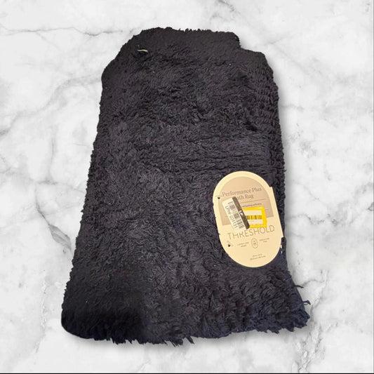 Soft black fleece throw blanket with tag, perfect for cozying up.