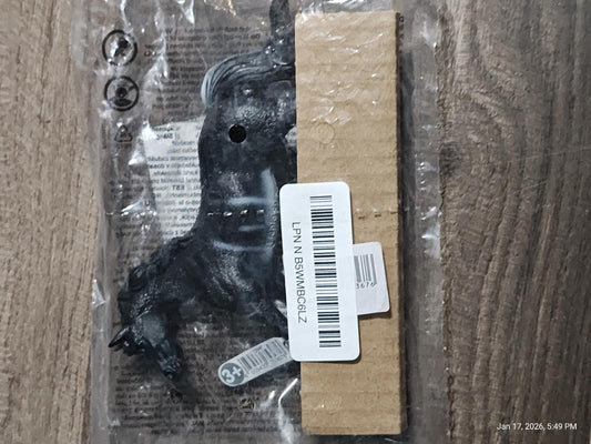 Product name not provided. Black plastic toy horse with packaging.