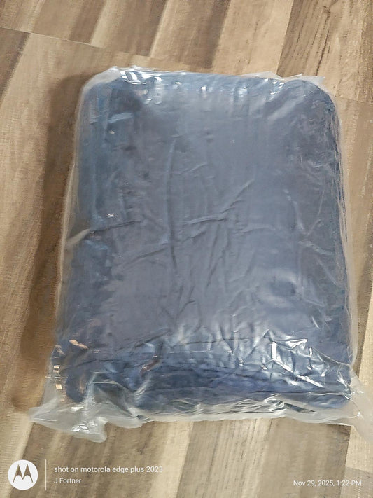 Blue fleece blanket packaged in plastic for easy storage.