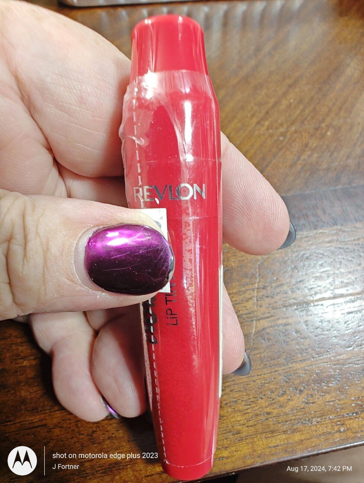 Revlon red lip crayon with a glossy finish held by a hand with purple nail polish.