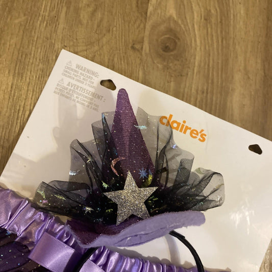 Claire's purple witch hat headband with glitter and star decoration.