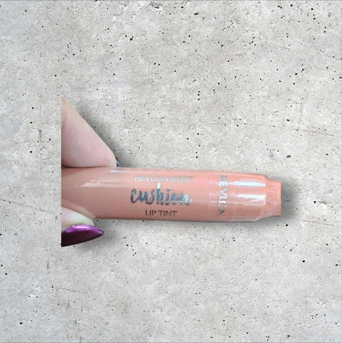 Cushion Lip Tint in a soft peach shade, featuring a sleek design and easy application.