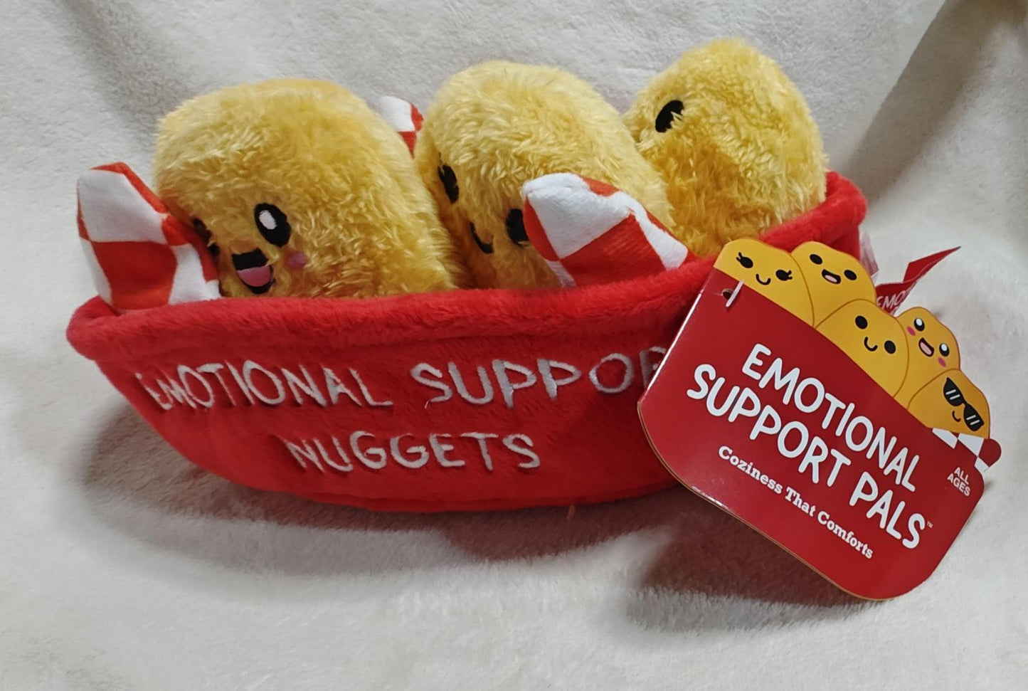 Emotional Support Nuggets plush toys in a red basket, featuring cute faces and soft textures.