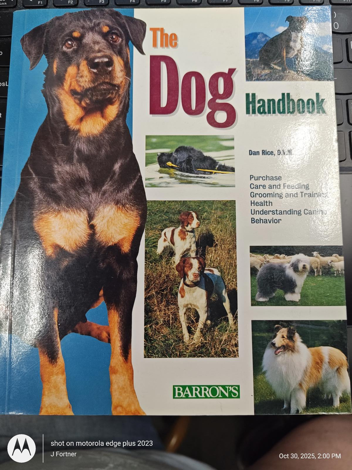 The Dog Handbook featuring various dog breeds and training tips on the cover.