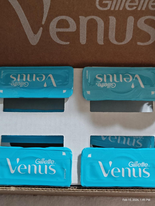 Gillette Venus razor blades in blue packaging, neatly arranged in a box.