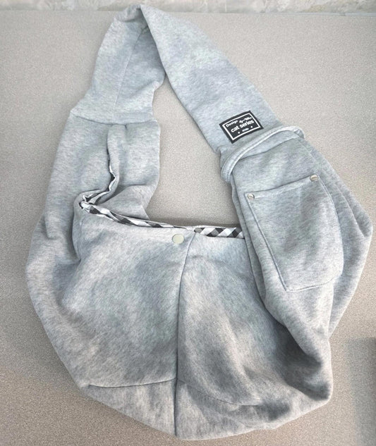 Gray hoodie with a unique design and pocket detail, perfect for casual wear.