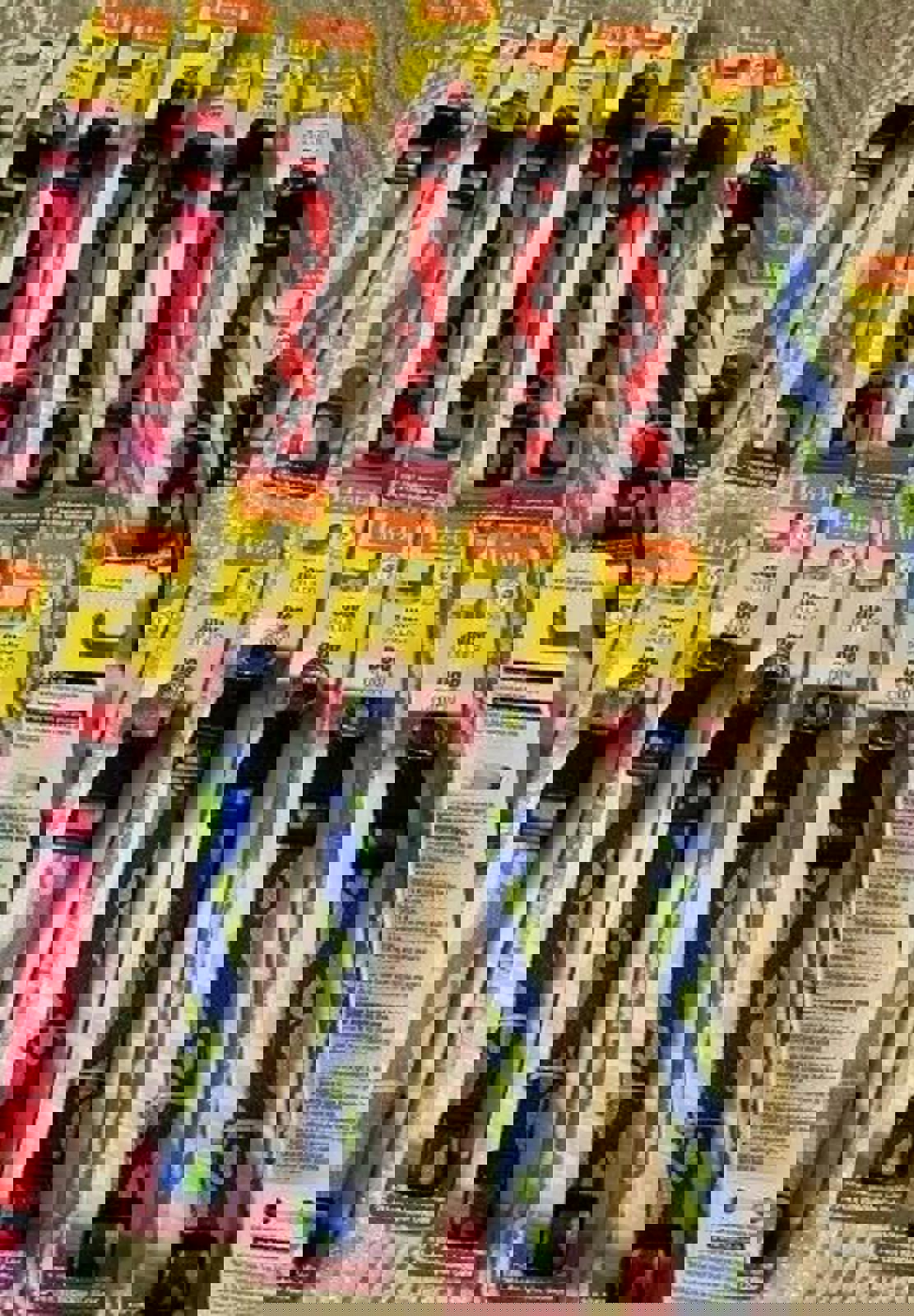 Hartz dog collars in various colors and patterns, including pink, red, and blue, displayed on packaging.