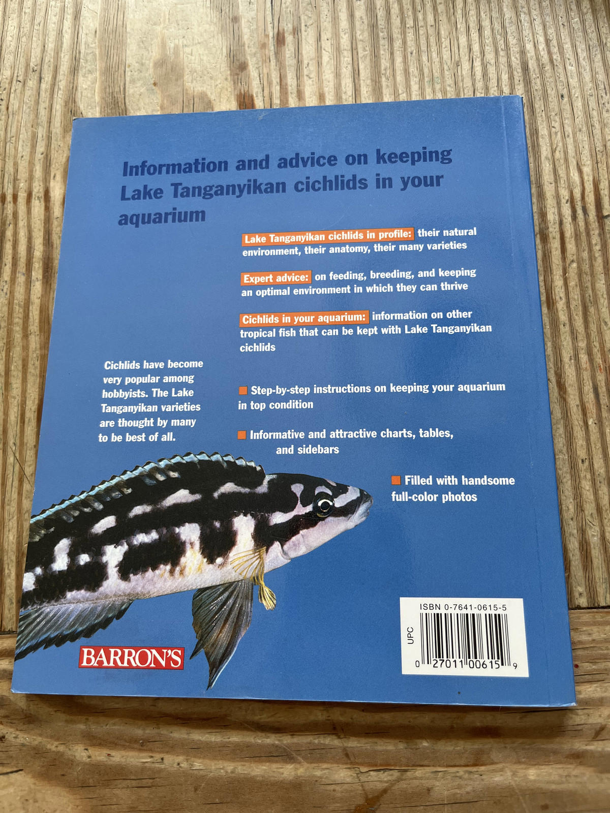 Lake Tanganyika Cichlids book cover featuring information on aquarium care and colorful fish.