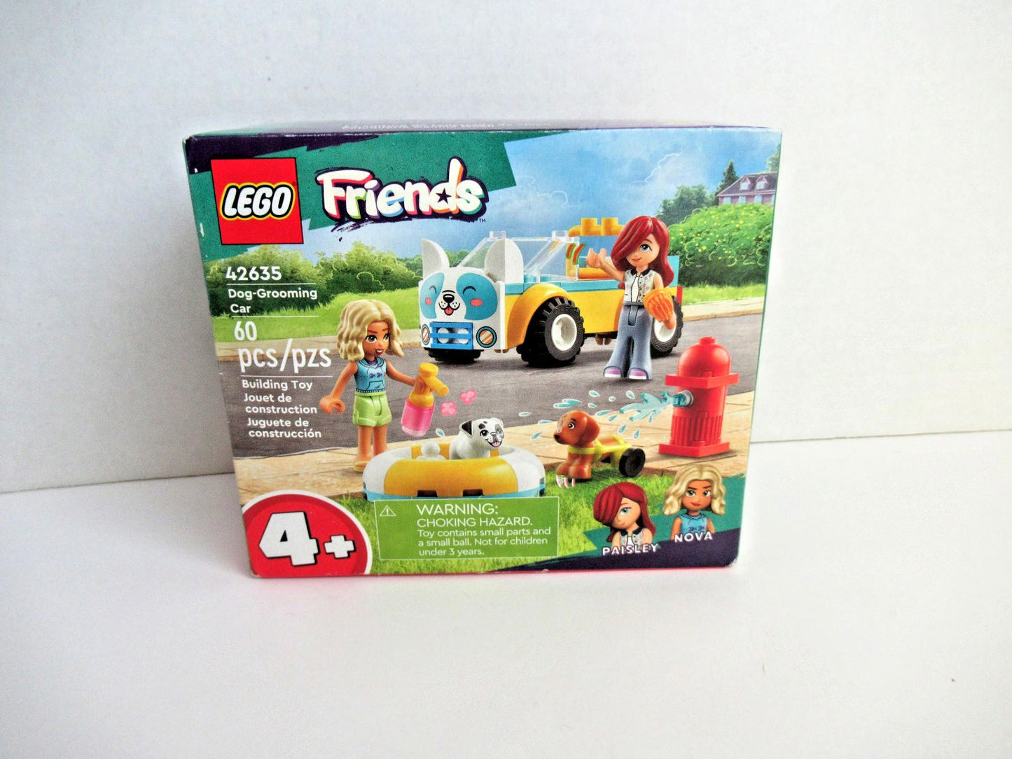 LEGO Friends 41365 set featuring a colorful bus, two mini-dolls, and a dog on a street scene.