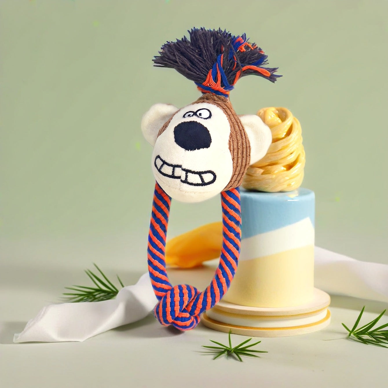 Lion Rope Toy features a playful design with a smiling lion head and colorful rope.