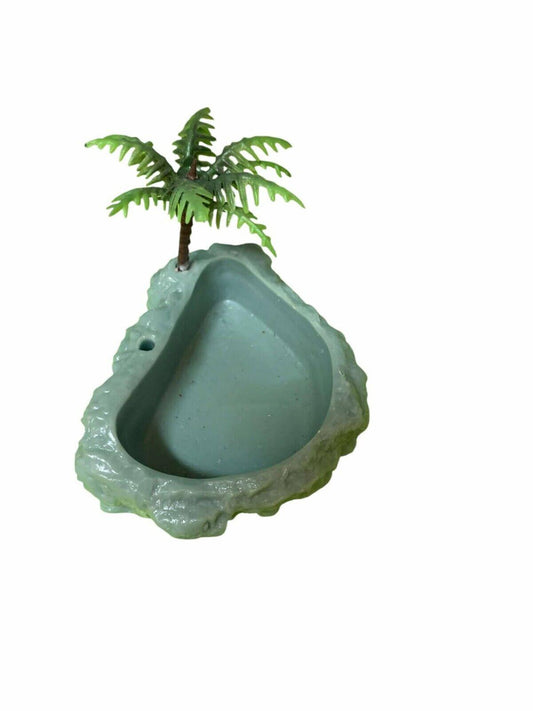 Miniature tropical-themed bird bath with palm tree design.