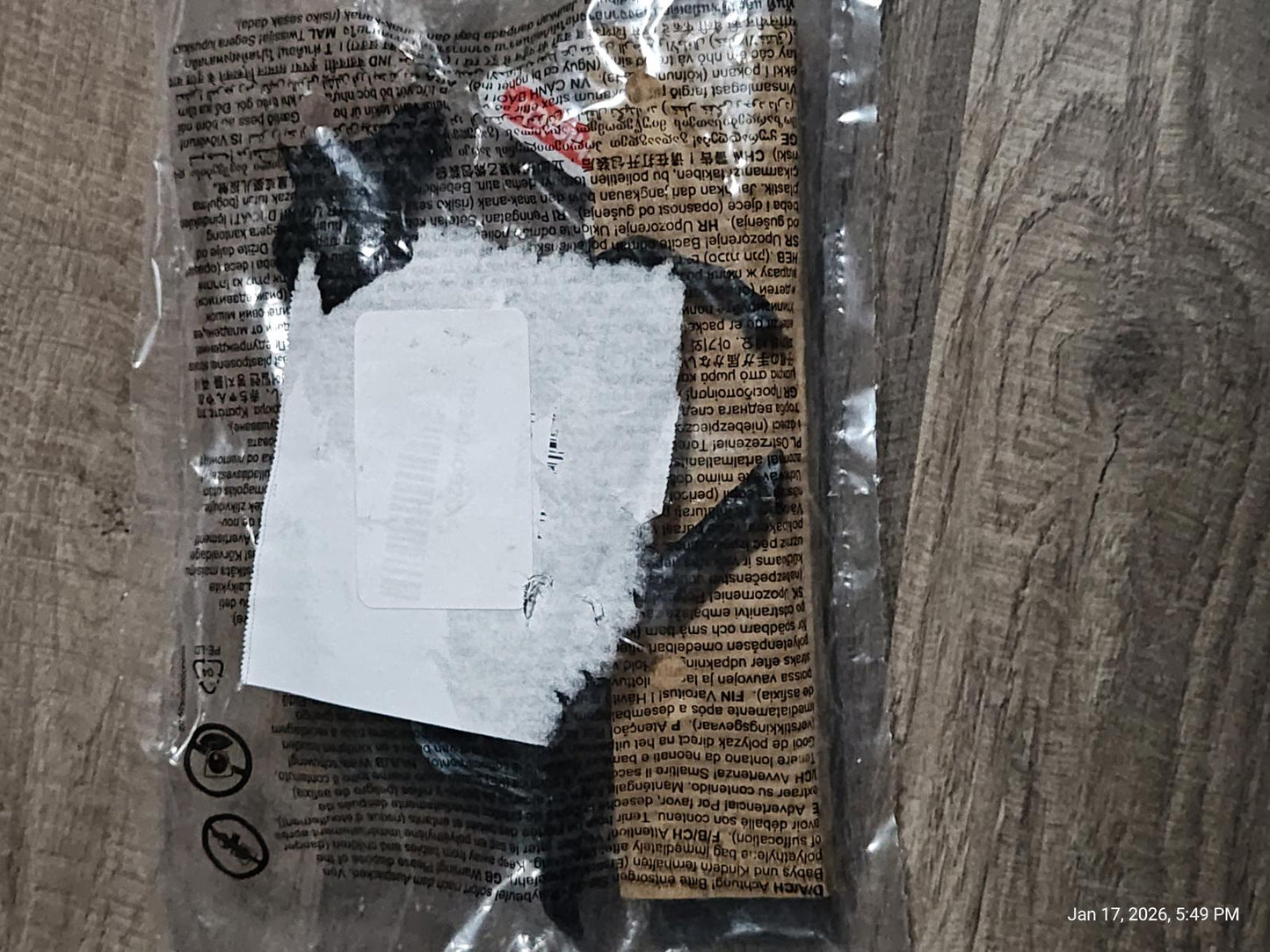 Product packaging for a mystery item with a torn label and visible contents.