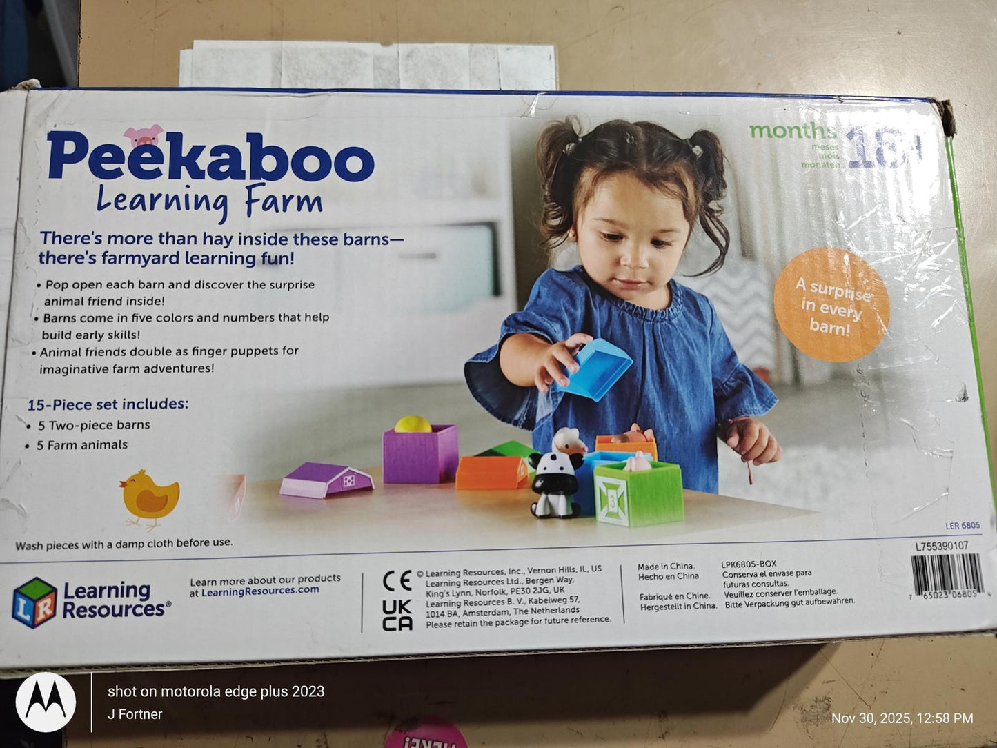 Peekaboo Learning Farm toy set featuring colorful blocks and a child playing with it.