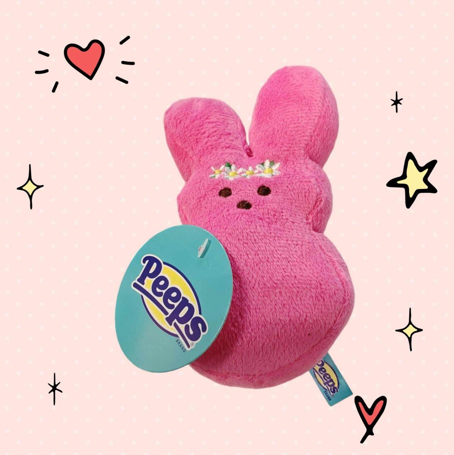 Peeps plush bunny in vibrant pink with floral accents and tag.