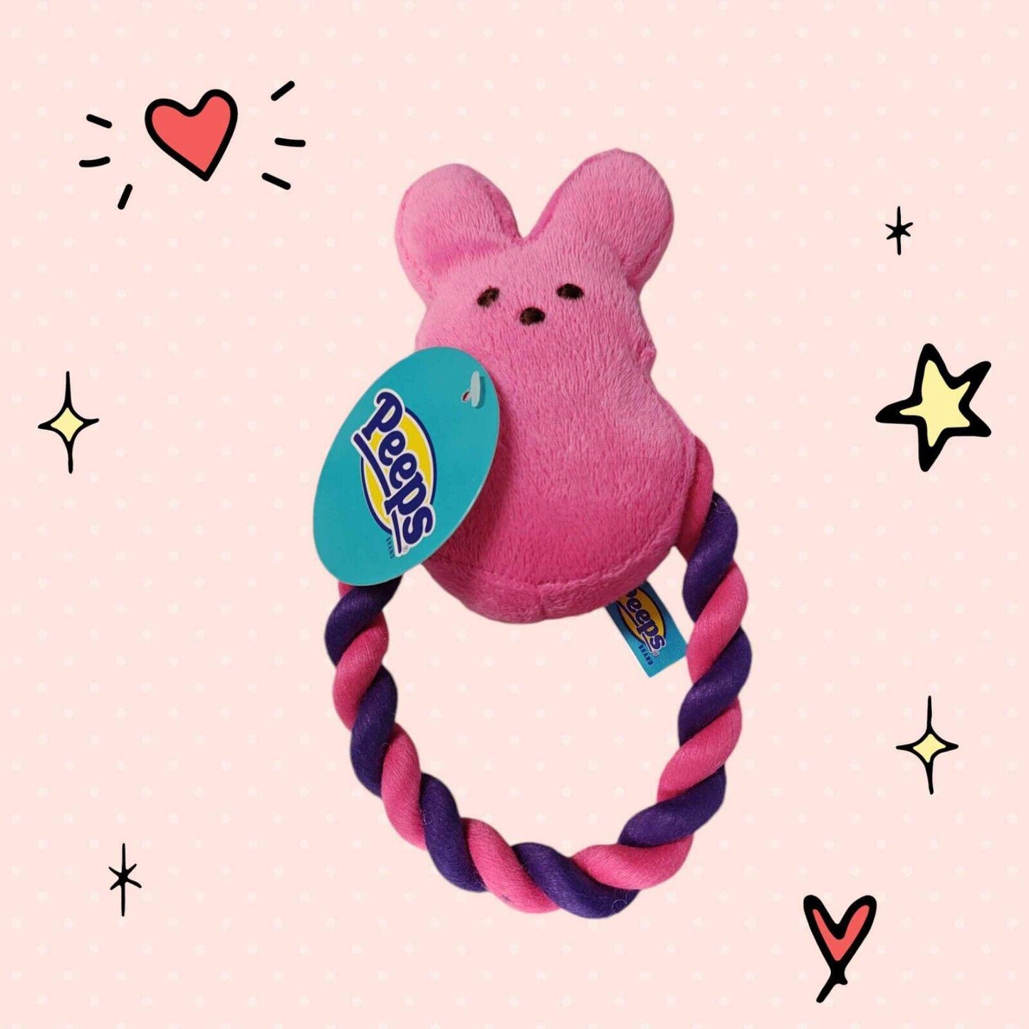 Peeps plush toy with a pink bunny design and a purple and pink rope handle.