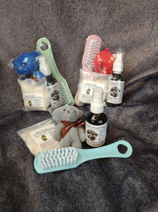 Pet grooming kit featuring a blue brush, grooming spray, and a plush toy for pets.
