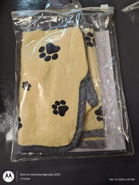 Pet Paw Print Blanket features a soft yellow fabric with black paw prints, packaged in a clear bag.
