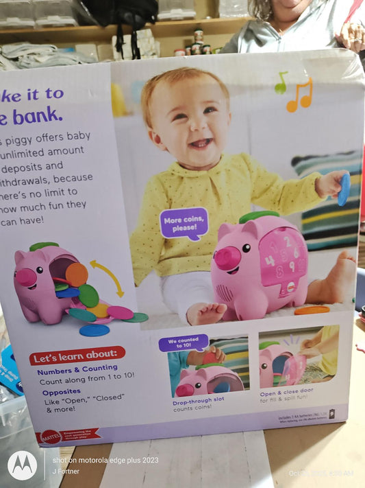 Piggy bank toy for babies featuring colorful coins and educational elements.