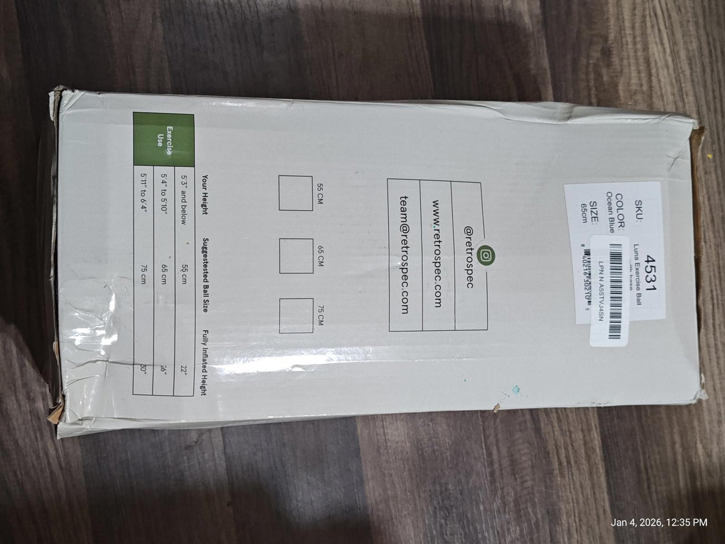 Product packaging box with shipping label and green logo.