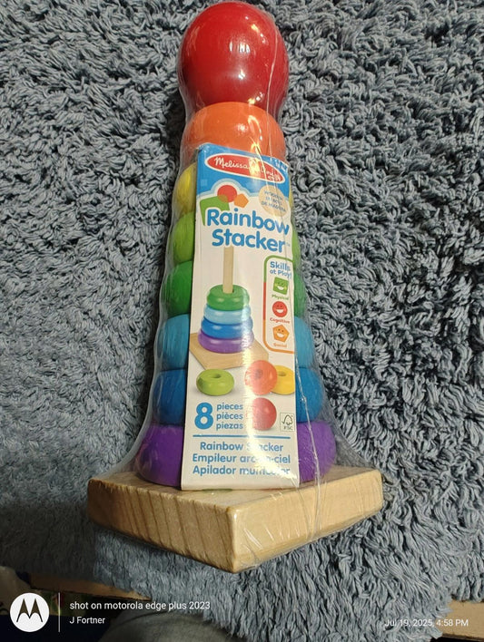Rainbow Stacker toy featuring colorful rings and a red top, designed for stacking and learning.