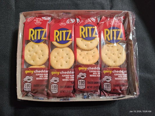 Ritz spicy cheddar crackers in a pack with four sleeves visible.