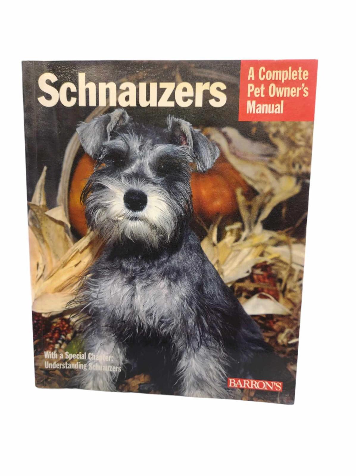 Schnauzers: A Complete Pet Owner's Manual cover featuring a gray Schnauzer among autumn leaves.