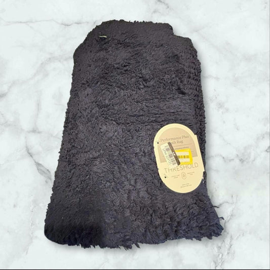Soft black faux fur throw blanket with tag attached.