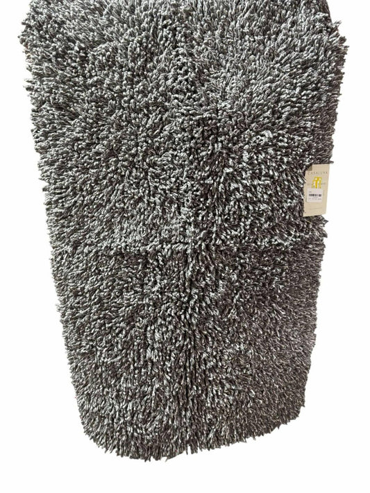 Soft gray microfiber bath mat with plush texture and non-slip backing.