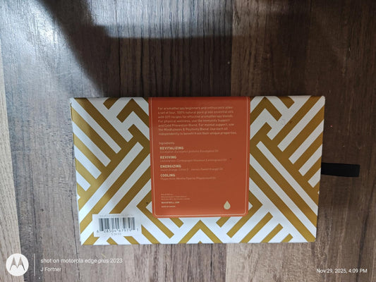Stylish geometric patterned notebook with gold and white design, featuring an orange label on the back.