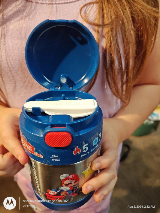 Super Mario themed container with a blue lid, held by a child, featuring 5 collectible pieces.
