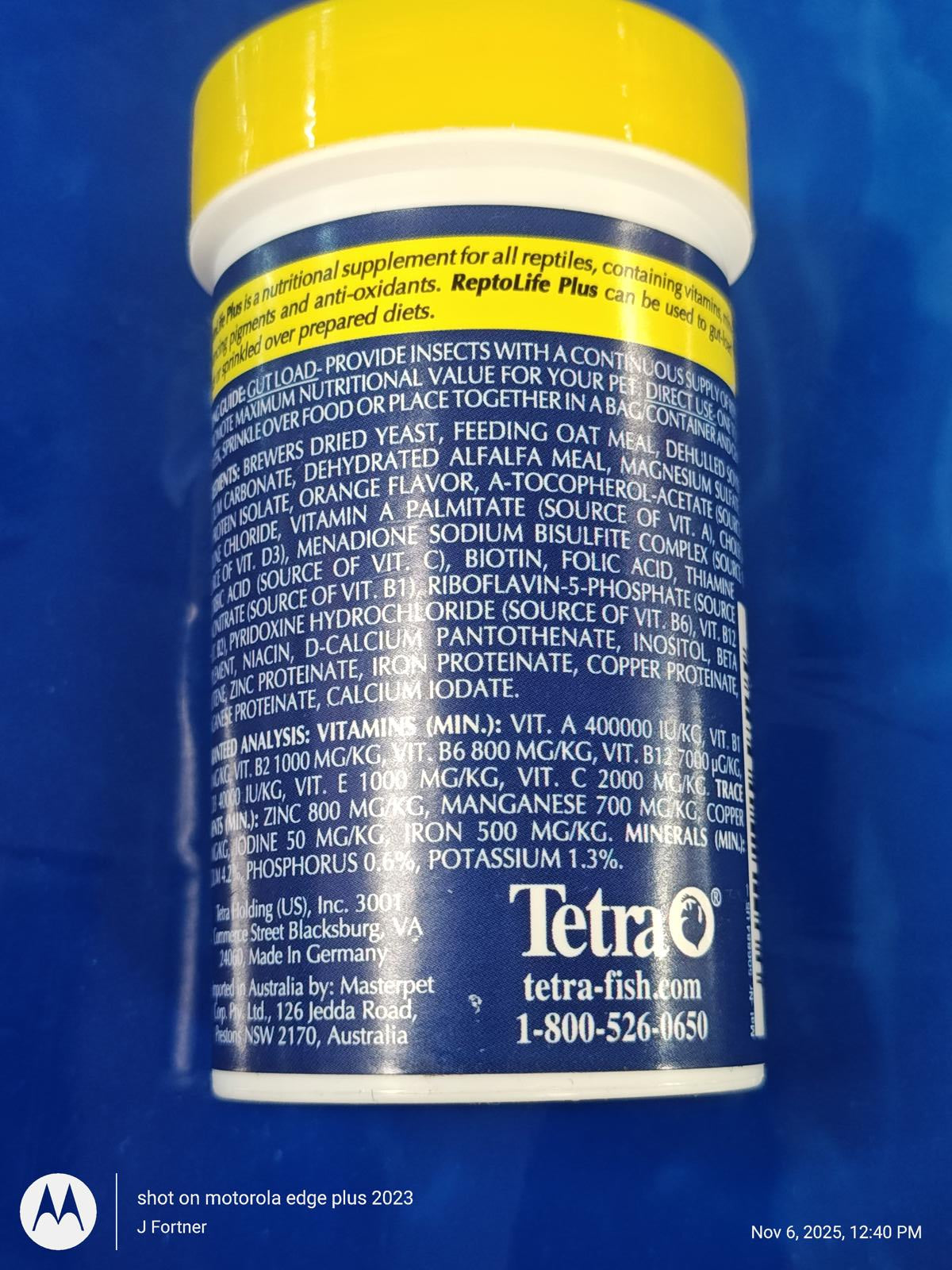 Tetra fish food container with yellow lid, featuring nutritional information and ingredients list.