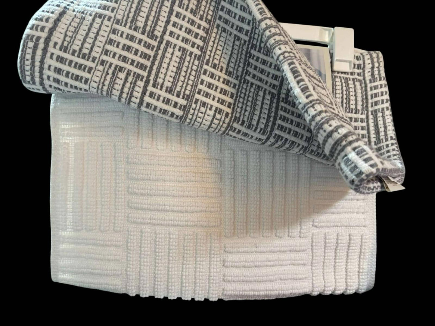 Textured white and gray bath towel set featuring a modern design.