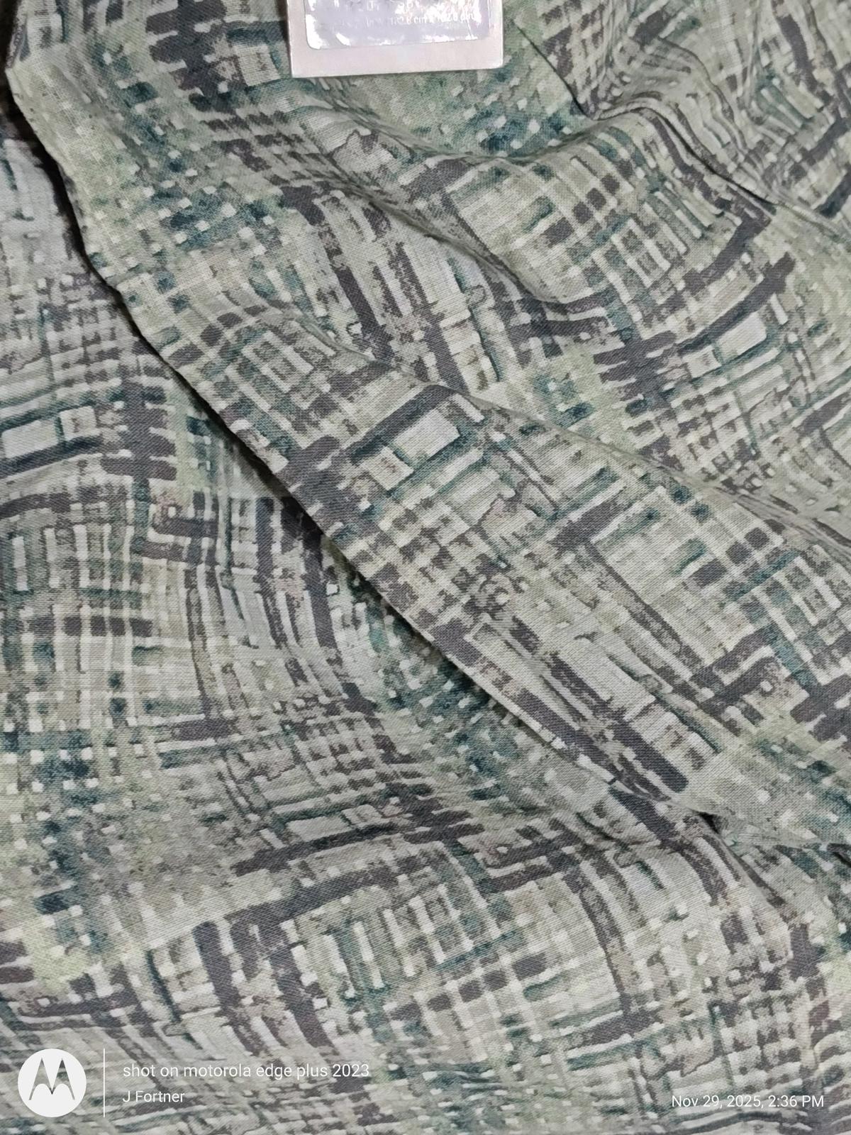 Textured green and gray patterned fabric scarf with a soft feel.