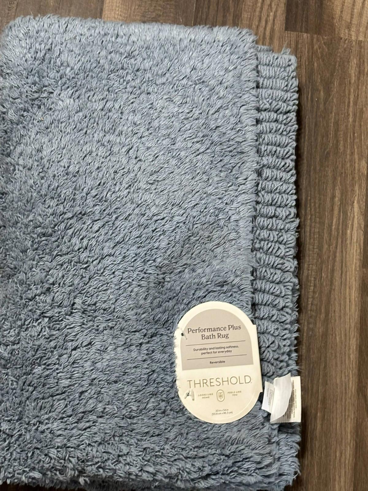 Threshold performance plush bath rug in soft blue color, featuring a textured surface.