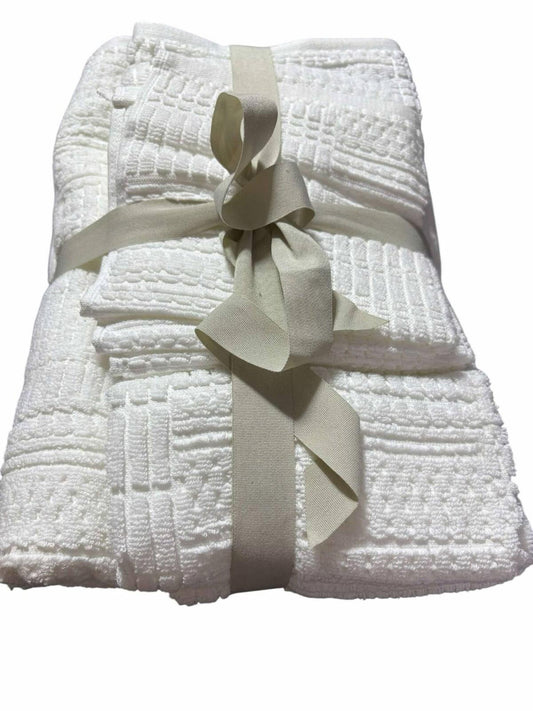 White Cotton Towel Set neatly tied with a ribbon, featuring textured patterns.