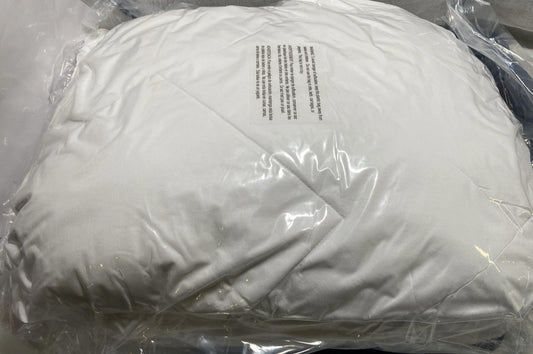 White Down Pillow with protective packaging and care instructions visible.