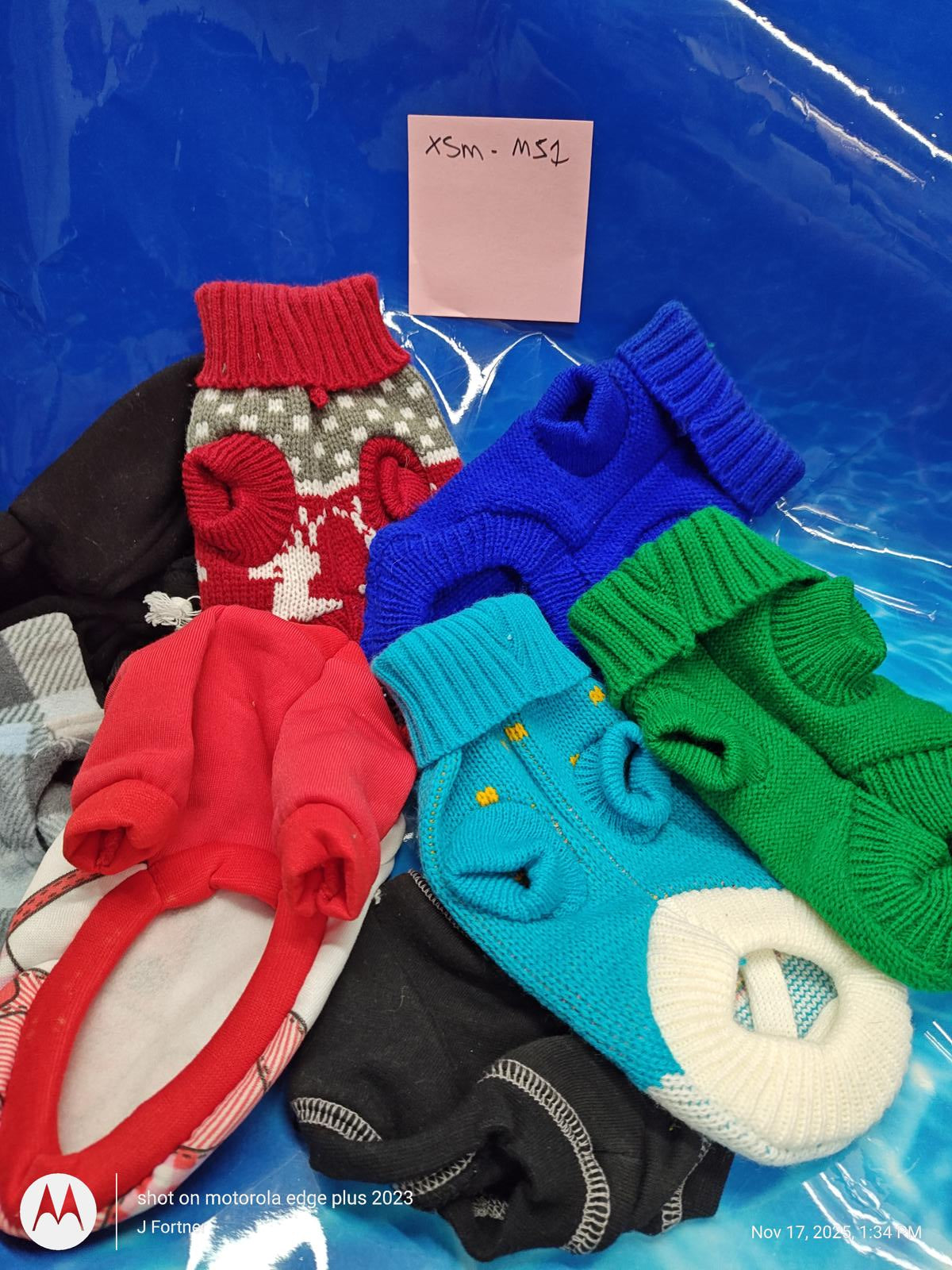 XSM, MS2 dog sweaters in various colors and designs, including red, blue, and green.