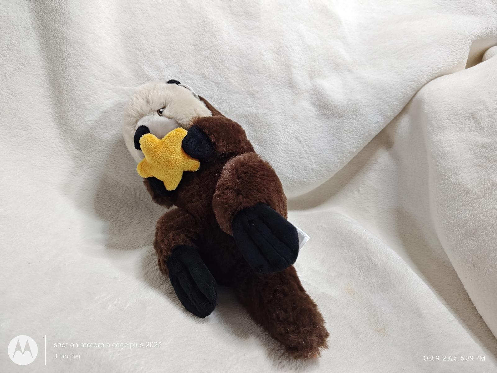 Plush Otter Toy holding a yellow star, soft and cuddly design.