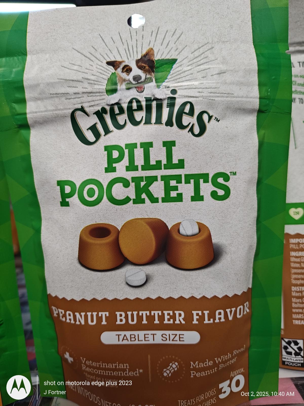 Greenies Pill Pockets peanut butter flavor tablets in a green bag, perfect for hiding pills.