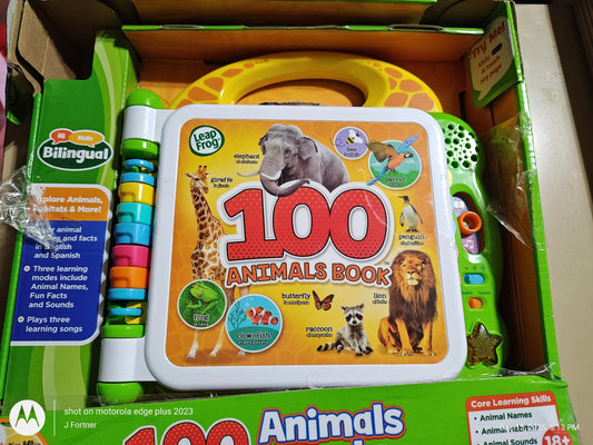 100 Animals Book featuring colorful illustrations of various animals like lions and elephants.