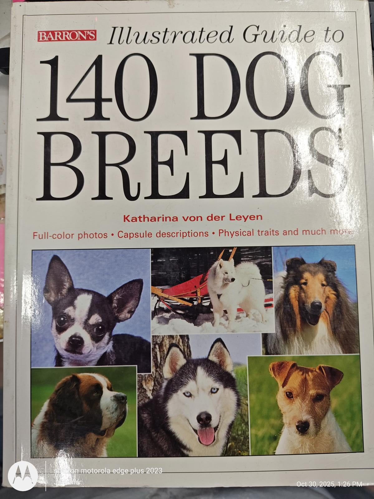 140 Dog Breeds book cover featuring various dog breeds with full-color photos and descriptions.