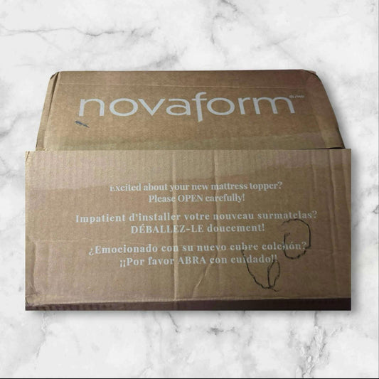 Novafrom mattress topper box with instructions for careful opening.