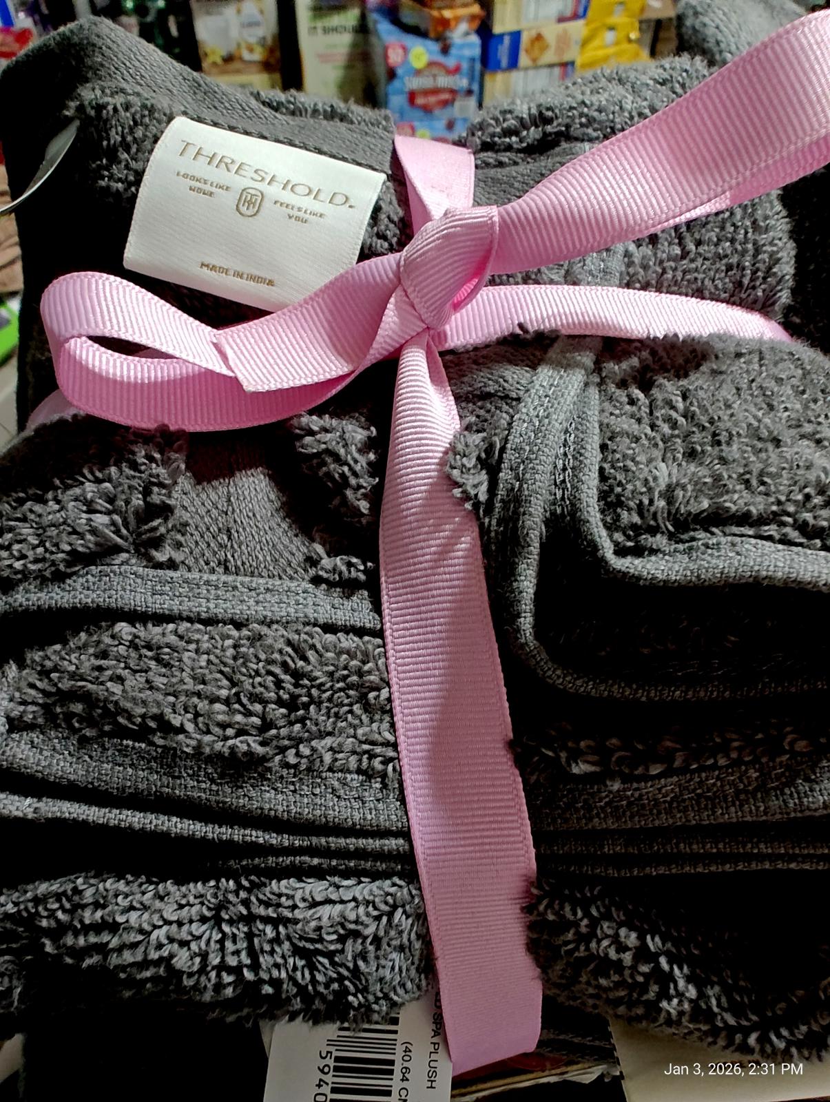 Threshold gray bath towels set wrapped with a pink ribbon.